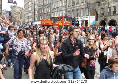 EDINBURGH, SCOTLAND, UK - AUGUST 08, 2015: crowd of people singing at the Fringe street festival on the Royal Mile, the main street of Edinburgh
