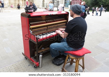 YORK, UK - CIRCA AUGUST 2015: Karl Mullen street piano player performing as usual on the street of York