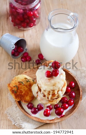 Russian quark pancakes with condensed milk and cranberry. Selective focus.