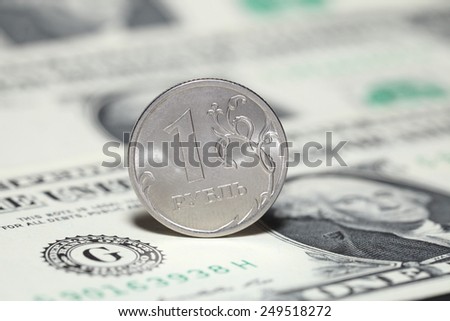 Ruble coin and dollar banknotes