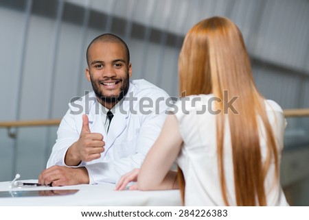 Doctor at work in a hospital. Portrait of confident and professional doctor therapist wearing white medical clothes with his patient. Medical concept.
