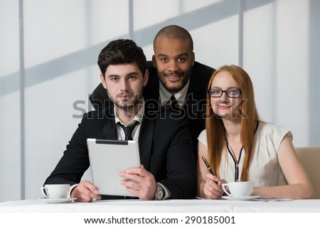 Business confidence. Three successful business people are at work. Business office concept