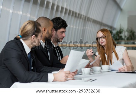 Business meeting with female boss. Team of young motivated successful business people are on the business meeting. Business meeting concept.