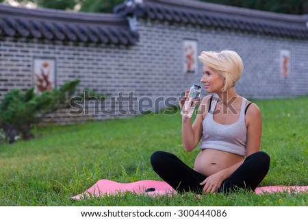 Perfect pregnant yoga. Portrait of young and beautiful woman making yoga in the nature. Pregnant yoga outdoor concept