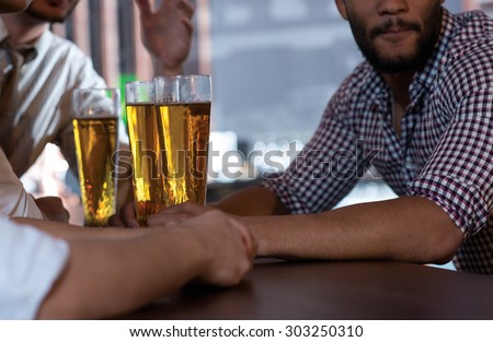 Beer evening. Close up of beer glasses in a pub. Guy are drinking beer.  Beer pub concept