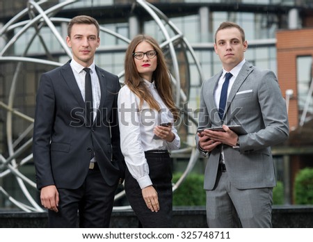 Proper business agreement. Group of confident and motivated business partners at work, discussing issues of business project. All are wearing formal suits. Outdoor business concept