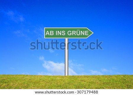 Street Sign showing nature trip in front of blue sky on green grass