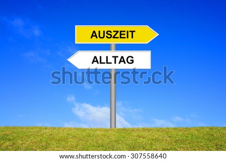 Street Sign showing time out or everyday life in german language in front of blue sky on green grass