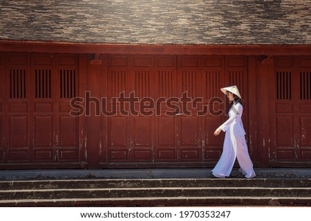 Asian woman Vietnam culture traditional dress on sandune during sunset ,traditional costume ,Muine Vietnam