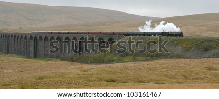 Steam Train crosses the famous Ribblehead Viaduct on the Settle to Carlisle railway in the Yorkshire Dales National Park.
