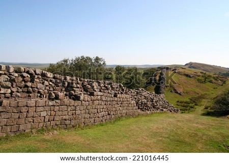 The Roman remains of the historic Hadrian\'s  Wall meandering over the Walltown Craggs in Northumberland, England.