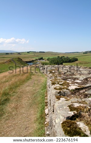 Historic Hadrian\'s Wall looking West from Cawfield Craggs towards Cawfield . The Roman remains follow the ridge line of these undulating hills in the Northern Pennines of Northumberland, England.