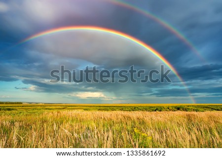 Similar – Image, Stock Photo Double rainbow over a green and autumn colored forest as a concept for the beauty of our nature in the rainy fall saison.