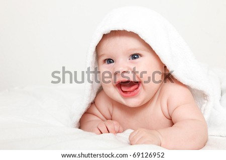 Laughing baby with towel