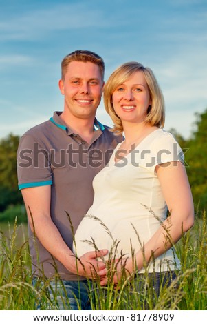 Pregnant couple in the park