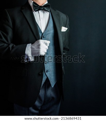 Portrait of Butler or Hotel Concierge in Formal Suit and White Gloves Standing at Respectful Attention. Copy Space for Service Industry and Professional Courtesy. Foto stock © 