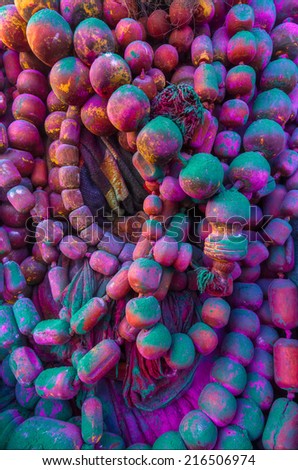 A set of necklaces fully covered in powdered color during the festival of Holi in Mathura, Uttar Pradesh, India.