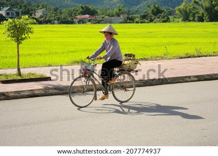 Dien Bien Phu, VIETNAM - July 28, 2014: A person riding a bike on a suburban road