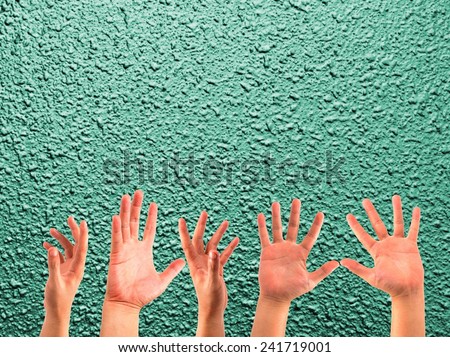 many hands on the blurred bright colors wall backgrounds