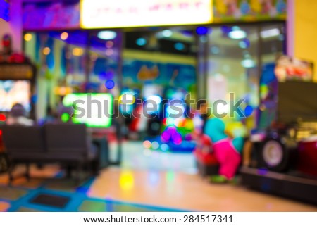 Arcade game machine shop blur background with bokeh image .