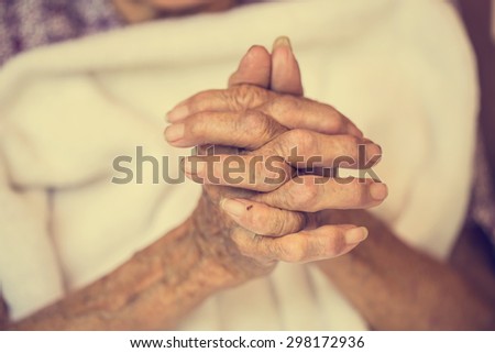 Hand of woman touching senior woman in clinic. : Vintage filter