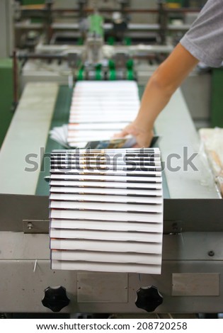 Print shop - Finishing line. Post press finishing line machine: cutting, trimming, paperback.