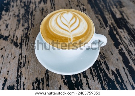 Similar – Image, Stock Photo Cappuccino with latte art on a wooden table in a cafe