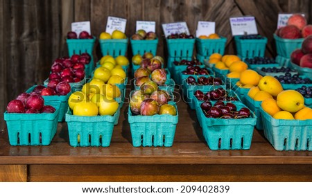 Rows of various fruits in boxes at country roadside stand in rural Pennsylvania.