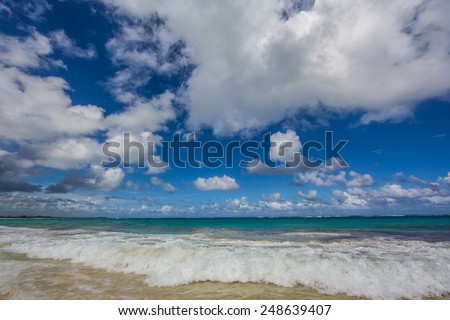 Dramatic view of clouds and ocean surf shot with wide angle lens.
