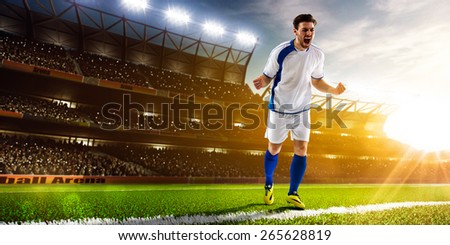 Soccer player in action on night stadium background panorama