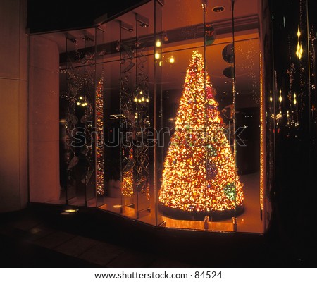 Window Dressing....an artificial tree with traditional Christmas lighting in a storefront window.