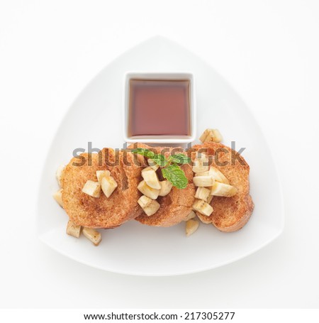 Toasted bread with pieces of banana and honey isolated on white