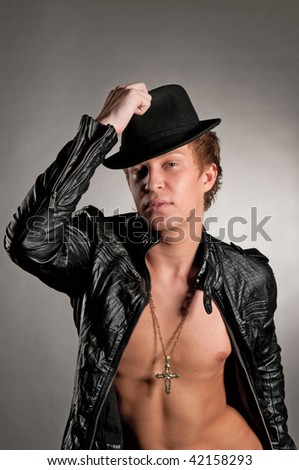 A young man in a leather jacket and a hat