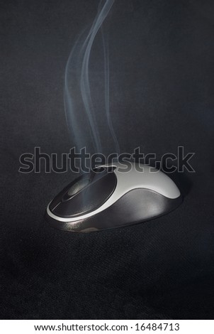 Black and silvery wireless wheel mouse smoking on black background