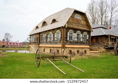 An old cart in front of a wooden house Zdjęcia stock © 