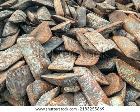 Ingots of cast iron stored in the warehouse. The form of cast iron: ingots, ingots solid condition. Transfer cast iron is cast iron used for further processing into steel. ストックフォト © 