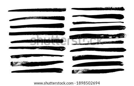 Collection of long black brush strokes drawn by hand. Vector illustration isolated on white background.

