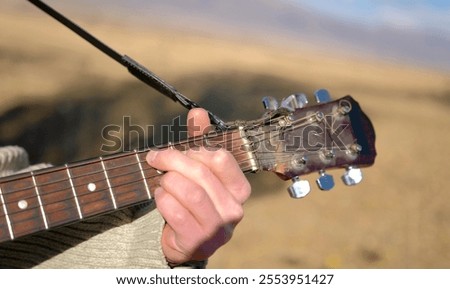 Similar – Image, Stock Photo Man clamping strings on guitar neck