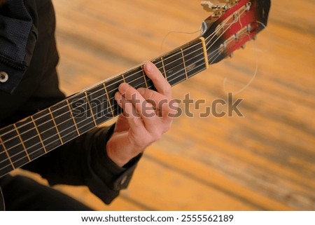 Image, Stock Photo Man clamping strings on guitar neck