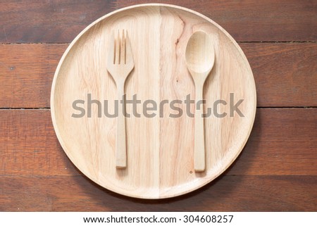Empty wood dish with wood fork and wood spoon