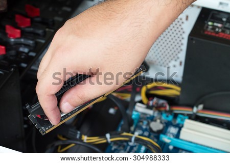 The technician is fixing computer.