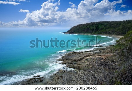 Beautiful landscape beach with rocky shore and clouds, Noosa Heads, Sunshine Coast, Australia
