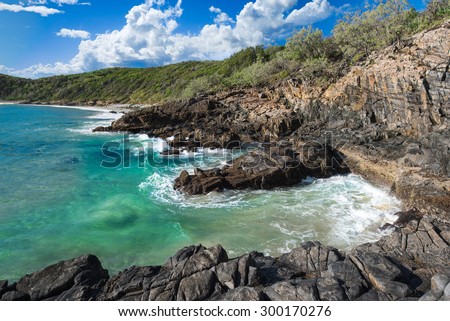 Crystal Clear Waves Hitting the Rocky Shore on a Beautiful Morning at Granite Bay, Noosa Heads, Sunshine Coast, Australia