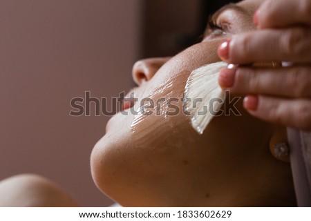 Similar – Image, Stock Photo Relaxed woman applies mineral clay mask on face for rejuvenation, has headband on head