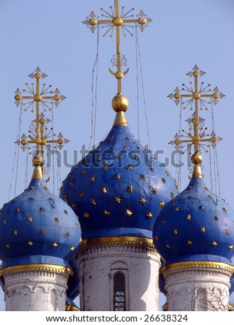 Christian cathedral with the blue domes covered with gold against the dark blue sky