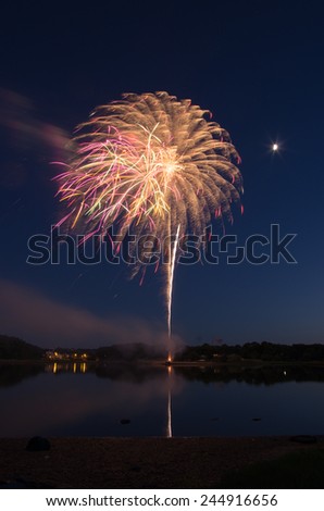 Fireworks go off over Black\'s Creek in Quincy, MA.