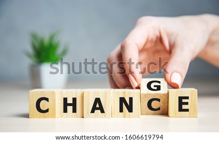 Businesswoman hand holding wooden cube with flip over block CHANGE to CHANCE word on table background. success, strategy, solution, business and Positive thinking concepts Photo stock © 