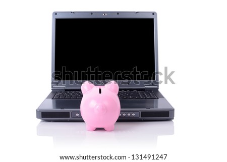 piggy bank looking at computer screen, copy space for screen. includes clipping path