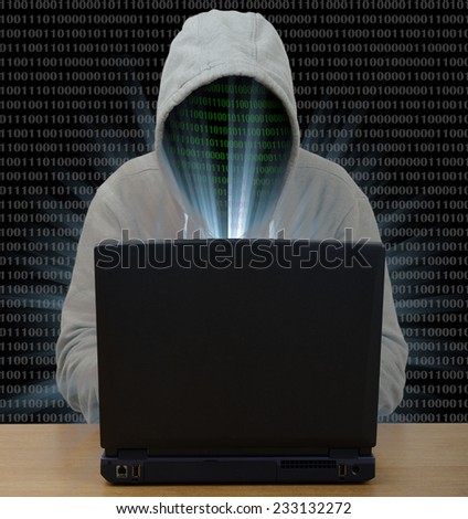 Hacker typing on a laptop with binary code in background