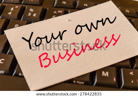Your own business Concept on black keyboard